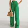 Lightweight high waist wide-leg pleated summer trousers for women by FJØRNA, shown in a natural pose.