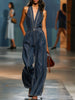 Dark blue denim FJØRNA women's sleeveless V-neck wide-leg jumpsuit, shown hanging, highlighting its relaxed fit and stylish design.