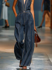 Dark blue denim V-neck sleeveless jumpsuit with wide-leg pants, styled by FJØRNA, shown on a mannequin.