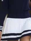 Navy blue FJØRNA women's mini dress with short sleeves and fitted silhouette, displayed on a hanger against a plain background.