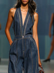 Dark blue denim FJØRNA sleeveless V-neck wide-leg jumpsuit for women, featuring a stylish V-neck and flowy wide-leg pants.