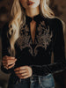Black velvet V-neck long sleeve top with embroidered details from FJØRNA, shown on a model.