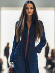 Dark blue FJØRNA women's denim jumpsuit with wide-leg pants and long sleeves, featuring topstitching details.