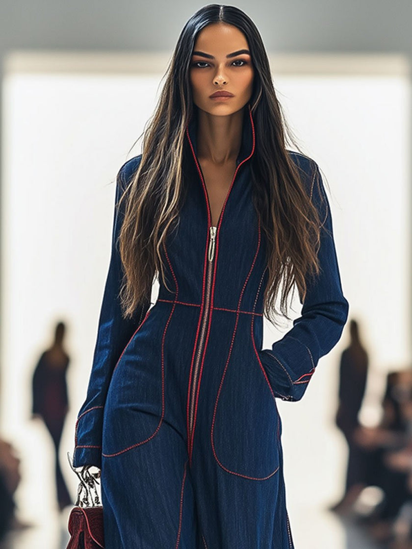 Dark blue FJØRNA women's denim jumpsuit with wide-leg pants and long sleeves, featuring topstitching details.
