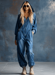Blue denim FJØRNA women's hooded button-front long sleeve jumpsuit, featuring a casual fit and stylish design.