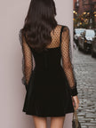 FJØRNA velvet evening dress with elegant draping and long sleeves, perfect for formal occasions.