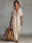 Red linen embroidered maxi dress for women by FJØRNA, featuring intricate embroidery and flowing fabric.