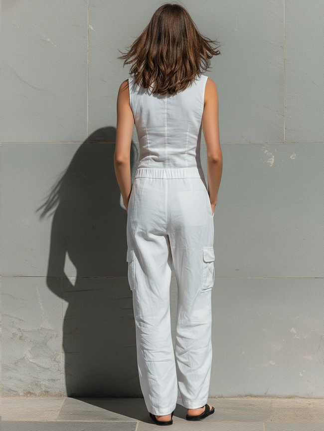 FJØRNA cotton blend sleeveless jumpsuit for women with V-neck, tailored fit, and single-breasted design, styled as pants.