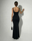 Black satin bodycon maxi dress by FJØRNA featuring a sleek, slim-fit design, sparkly fabric, and cami-style top for elegant wear.