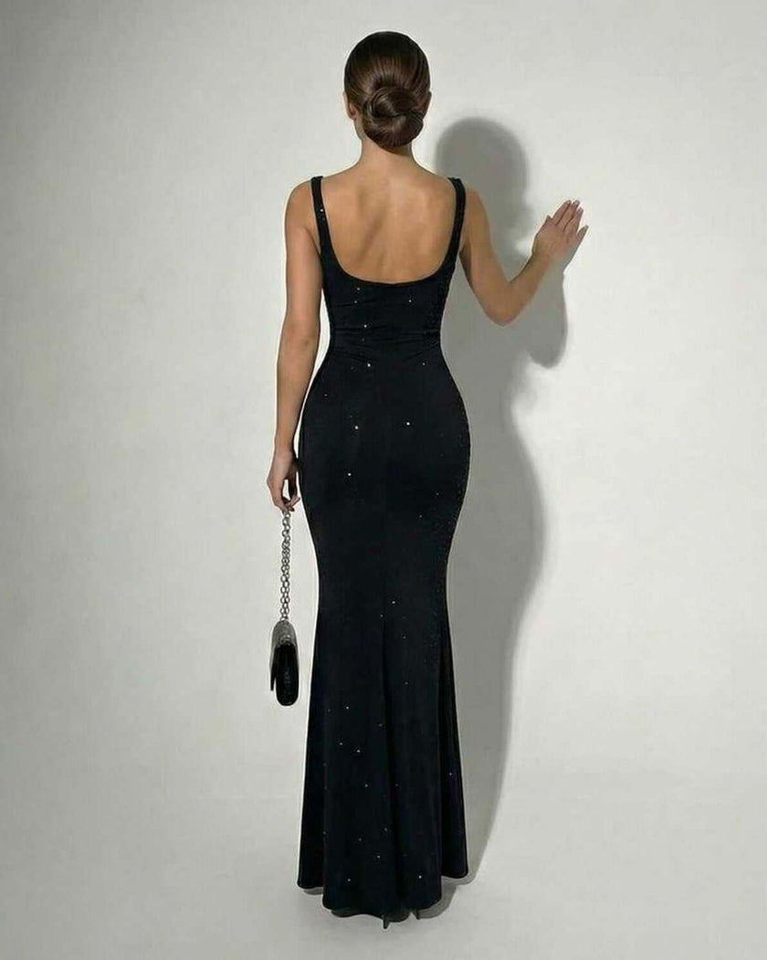Black satin bodycon maxi dress by FJØRNA featuring a sleek, slim-fit design, sparkly fabric, and cami-style top for elegant wear.