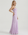 Lavender lace spaghetti-strap maxi dress by FJØRNA with floral print, sheer fabric, and lace-up back, ideal for wedding guests.