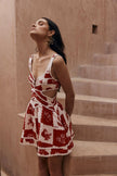 FJØRNA Leila printed cut-out mini dress in white, featuring a stylish design with cut-outs and vibrant print details.