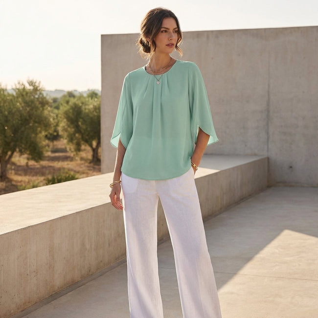 FJØRNA women's summer blouse with pleated design, casual style, worn as a top in a lifestyle setting.
