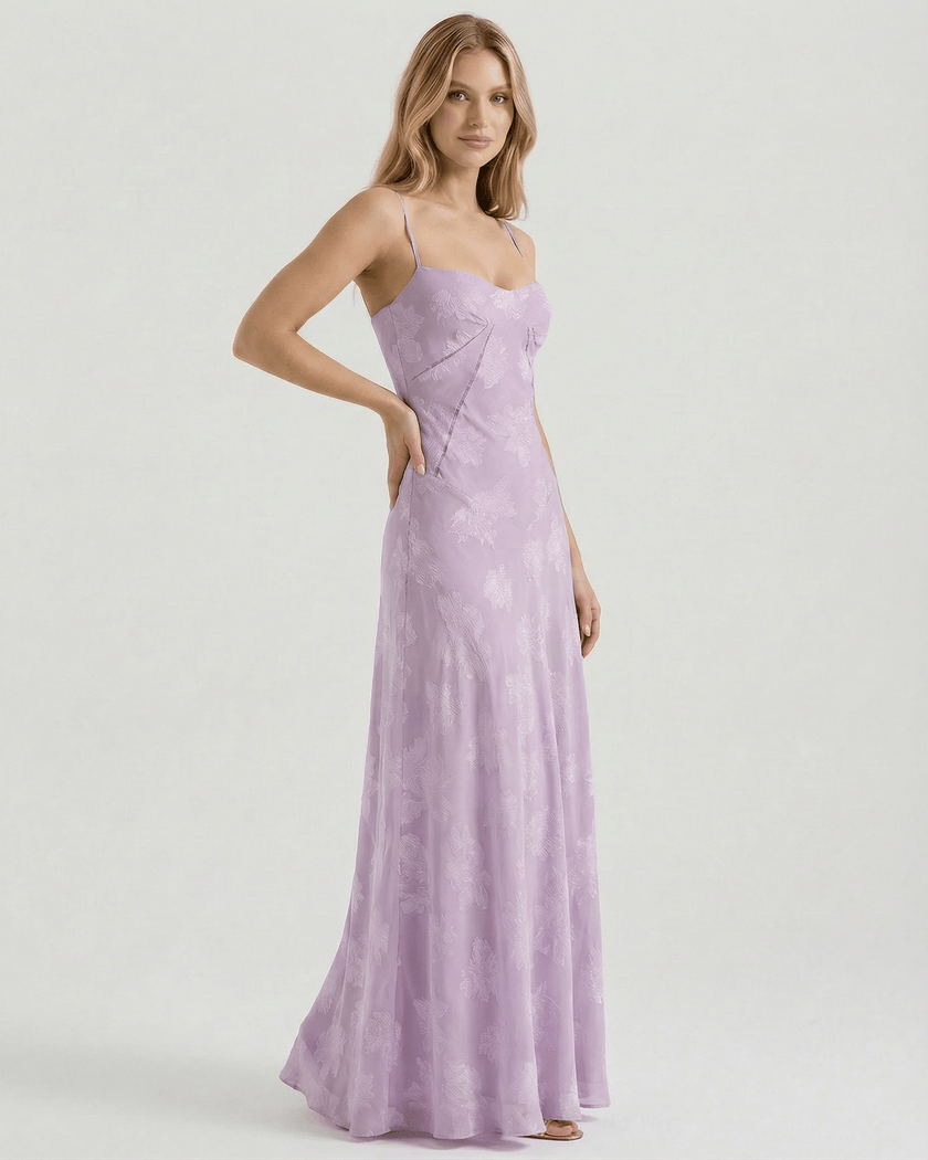 Lavender floral lace-up back maxi dress for women by FJØRNA, featuring sheer fabric and spaghetti straps, perfect for wedding guests.