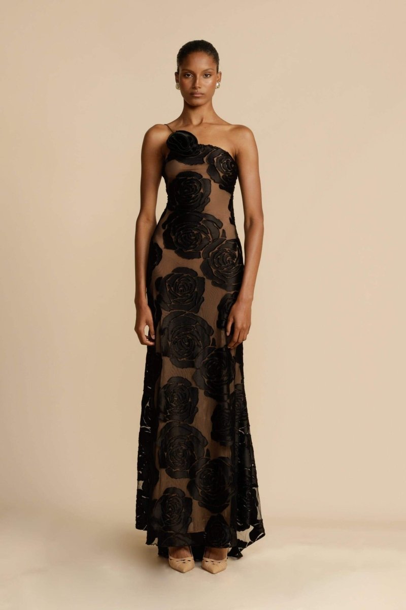 FJØRNA Lindsay floral printed one-shoulder maxi dress in white with a flowing silhouette and vibrant floral pattern.