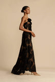 FJØRNA Lindsay floral printed one-shoulder maxi dress in white with a flowing silhouette and vibrant floral pattern.