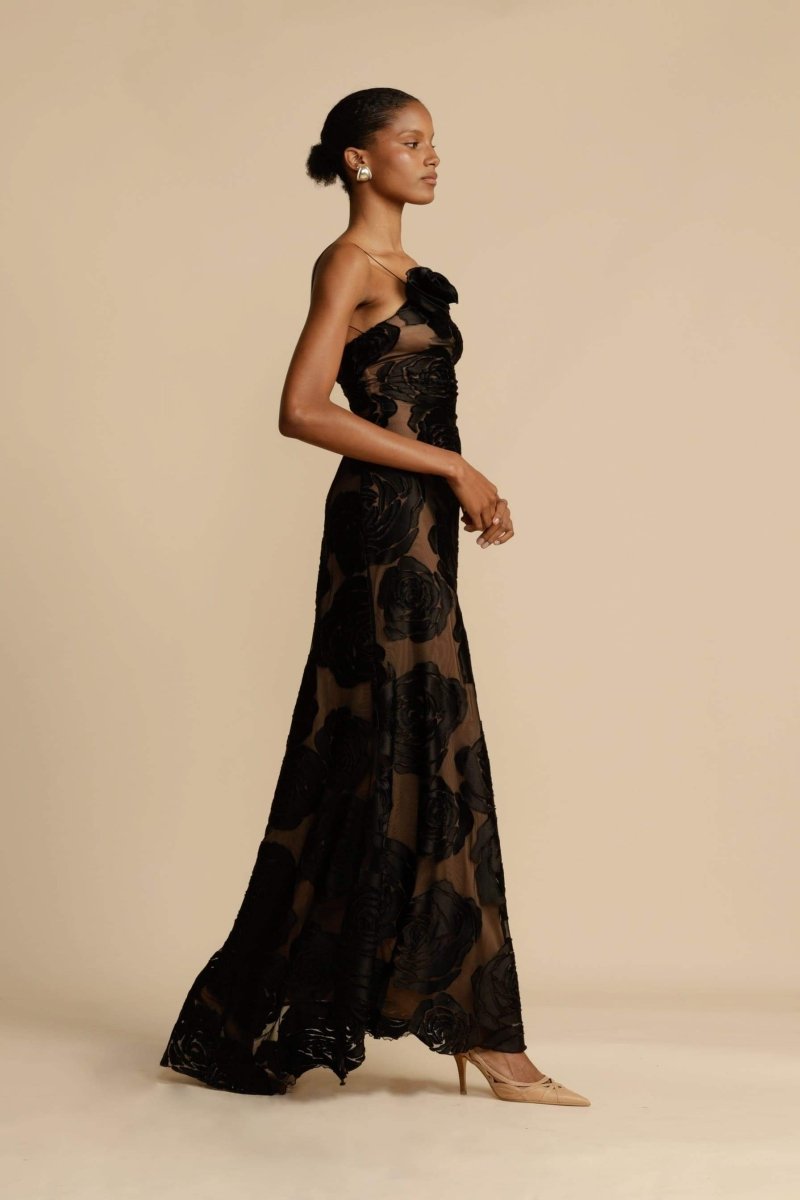 FJØRNA Lindsay floral printed one-shoulder maxi dress in white with a flowing silhouette and vibrant floral pattern.