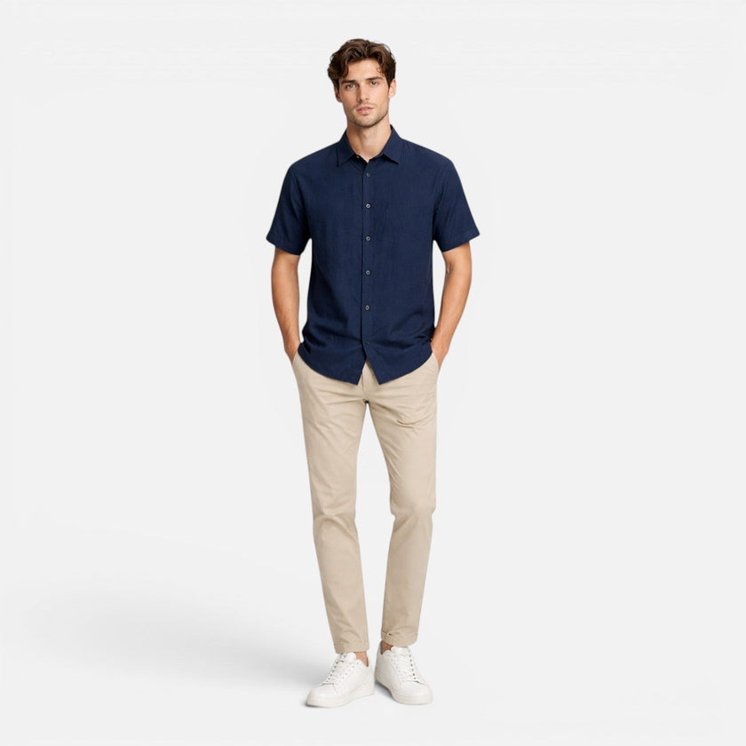 Men's FJØRNA linen shirt with short sleeves, breathable cotton blend fabric, button-up design, suitable for warm weather.