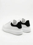 FJØRNA men's white lace-up trainers with minimalist design, back view showing sleek style and comfortable sole for everyday wear.