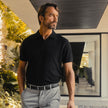 Black vegan leather ratchet belt by FJØRNA, adjustable unisex belt with a sleek buckle, suitable for men and women.