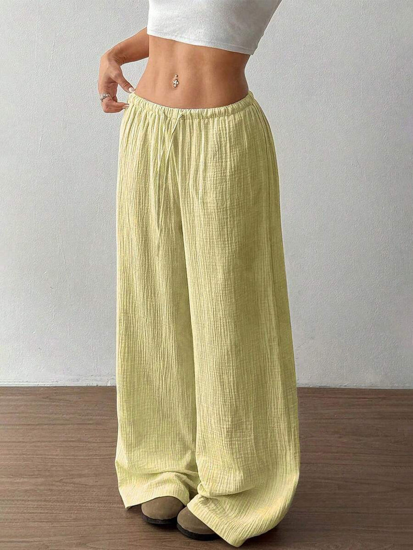 FJØRNA women's lightweight summer trousers with wide leg, drawstring waist, and elastic band for a casual, comfortable fit.