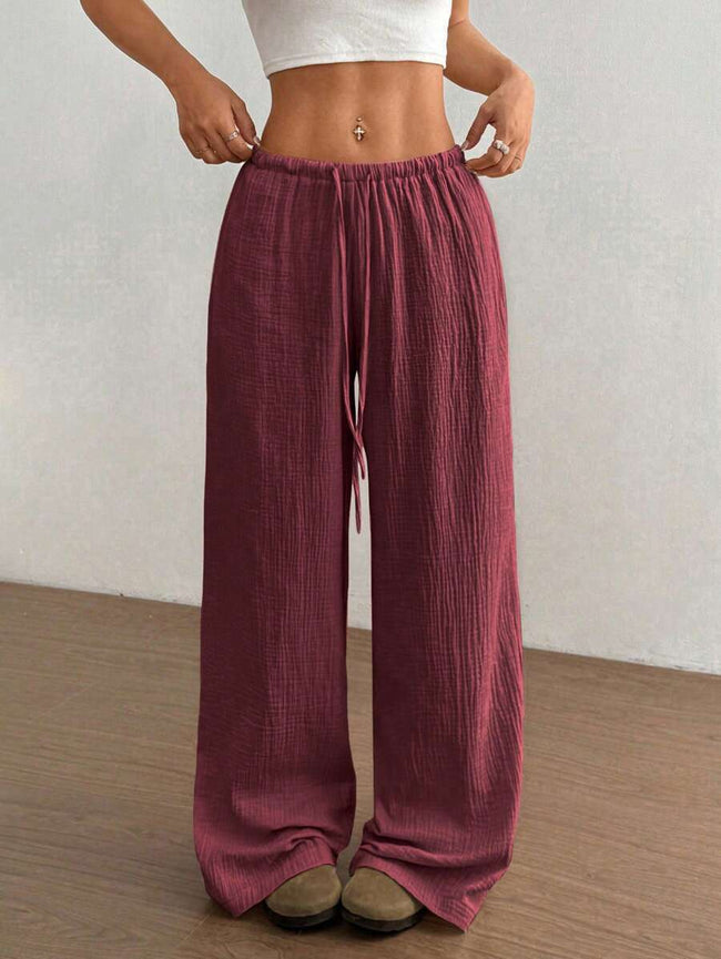 FJØRNA women's lightweight summer trousers with wide leg, drawstring waist, elastic band, casual style, in beige fabric.
