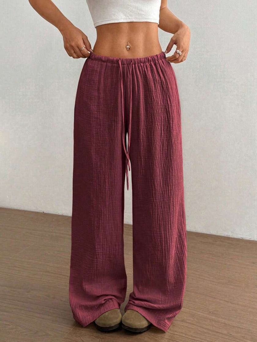 FJØRNA women's lightweight summer trousers with wide leg, drawstring waist, elastic band, casual style, in beige fabric.