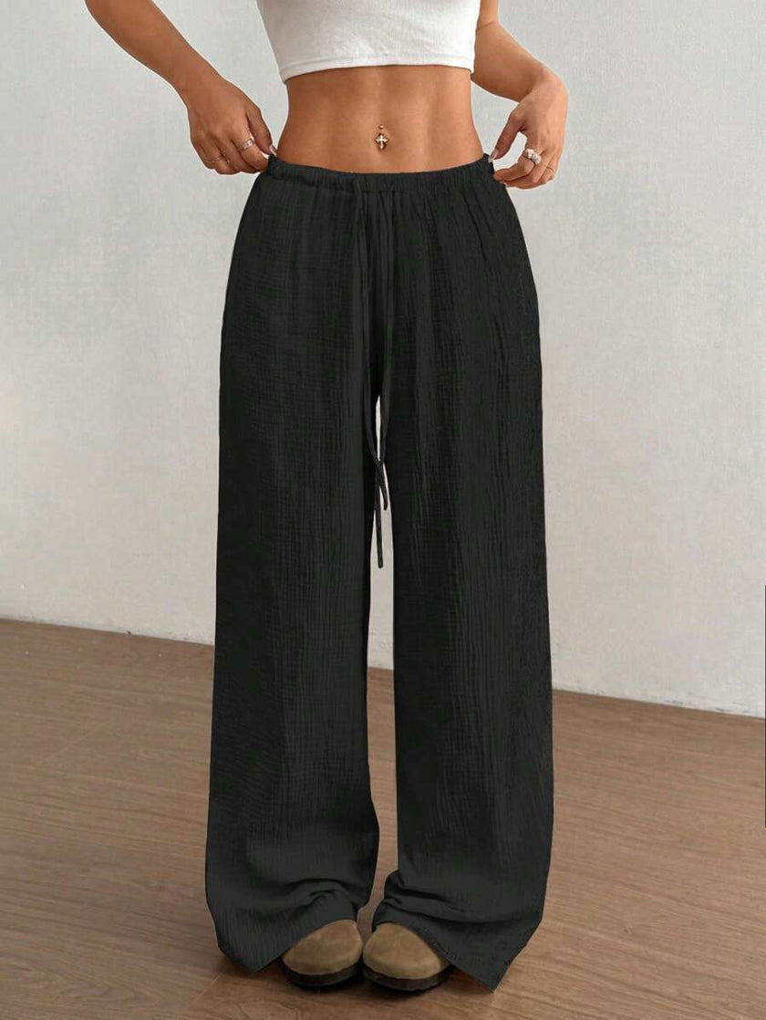FJØRNA women's lightweight summer trousers with wide leg, drawstring waist, and elastic band for casual comfort.