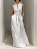 Full-body image of a woman in a FJØRNA linen V-neck maxi dress, showcasing a chic, relaxed fit and lightweight fabric.