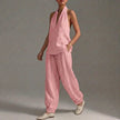 Pink FJØRNA two-piece women's co-ord set with V-neck top and matching pants, featuring pocket details, perfect for summer.