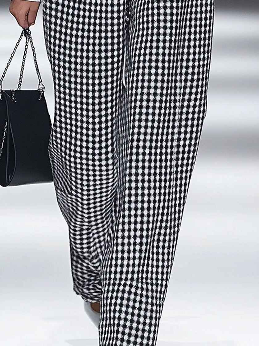 White houndstooth tailored women's straight-leg trousers from FJØRNA, shown flat with detailed fabric close-up.
