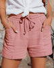 FJØRNA women's lightweight summer shorts with wide leg fit and drawstring waist, shown in a casual outdoor setting