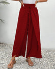 Red FJØRNA women's lightweight summer trousers with wide leg design, breathable fabric, perfect for warm weather.