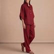 Red FJØRNA women's two-piece co-ord set featuring a button-front top and matching pants, stylish and elegant for diverse occasions.