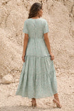 FJØRNA sage green floral print dress with long sleeves and a flowing silhouette, perfect for spring or summer occasions.