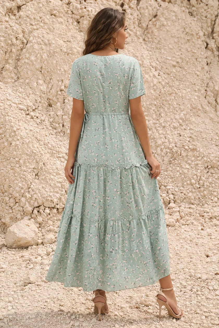 FJØRNA sage green floral print dress with long sleeves and a flowing silhouette, perfect for spring or summer occasions.