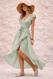 Sage green FJØRNA asymmetric dress with flowing fabric and elegant drape, showcasing a stylish, modern design.