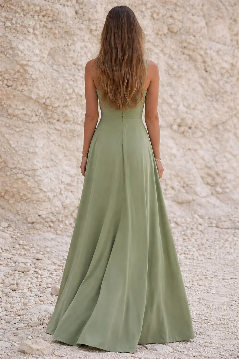 Sage green FJØRNA wedding guest dress with elegant flowy fabric and stylish design, perfect for special occasions.