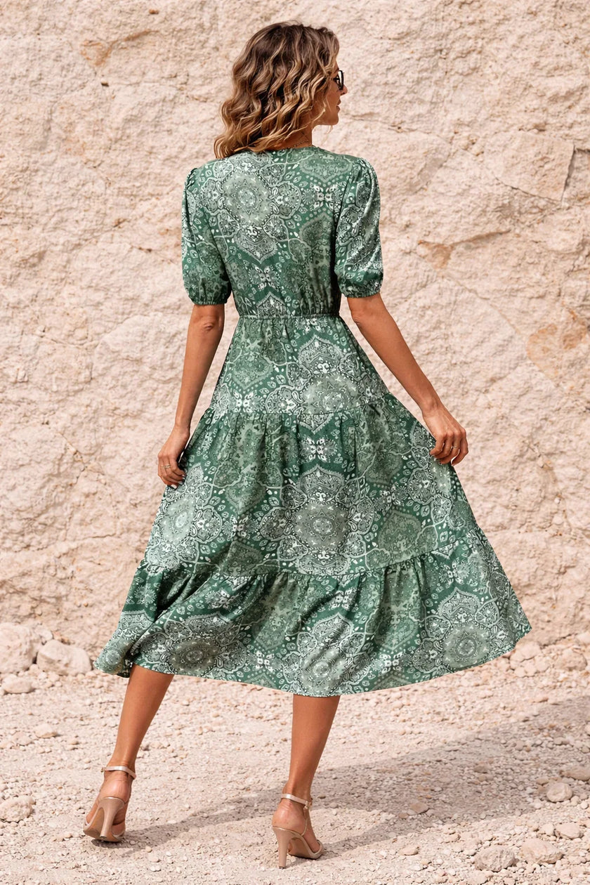 Sage green FJØRNA flowy dress with a lightweight, elegant fabric and relaxed fit, perfect for casual or semi-formal occasions.