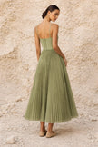 Sage green FJØRNA pleated midi dress with long flowing sleeves and a relaxed, elegant silhouette.