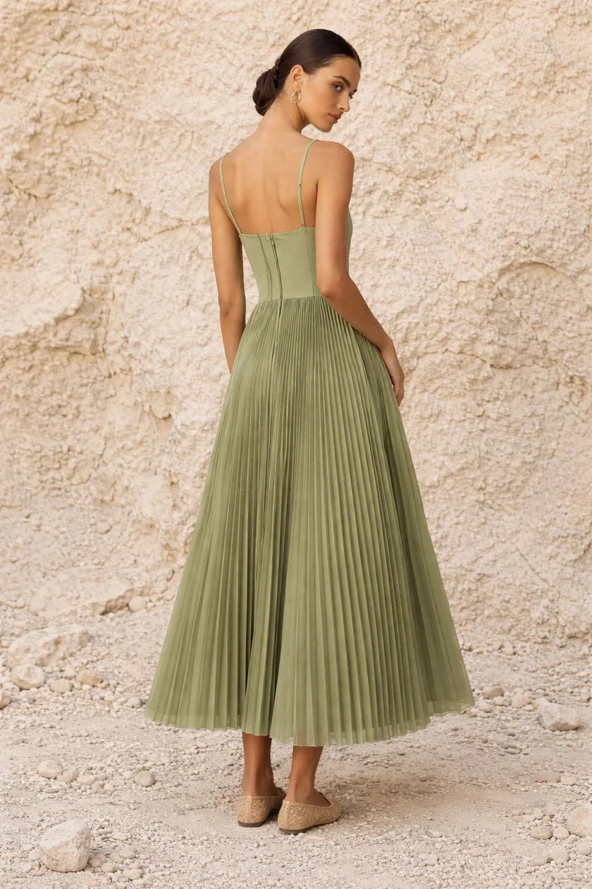 Sage green FJØRNA pleated midi dress with long flowing sleeves and a relaxed, elegant silhouette.