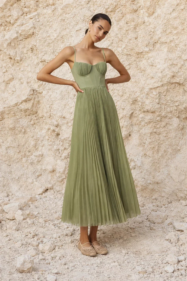 Sage green pleated midi dress from FJØRNA featuring a flowing silhouette and elegant pleats.