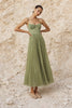 Sage green pleated midi dress from FJØRNA featuring a flowing silhouette and elegant pleats.