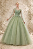 Sage green tulle wedding guest dress by FJØRNA, featuring a flowing silhouette and delicate fabric for elegant occasion wear.