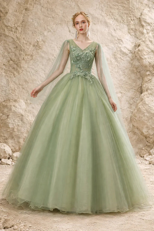 Sage green tulle wedding guest dress by FJØRNA, featuring a flowing silhouette and delicate fabric for elegant occasion wear.