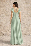 Sage green plus size FJØRNA dress with a slit, flowing fabric, and elegant design for a stylish look.