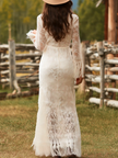 White lace V-neck maxi dress by FJØRNA featuring delicate lace details and a flowing silhouette for elegant evening wear.