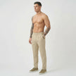Men's tailored cream trousers from FJØRNA featuring a slim fit design and classic style, shown on a model.