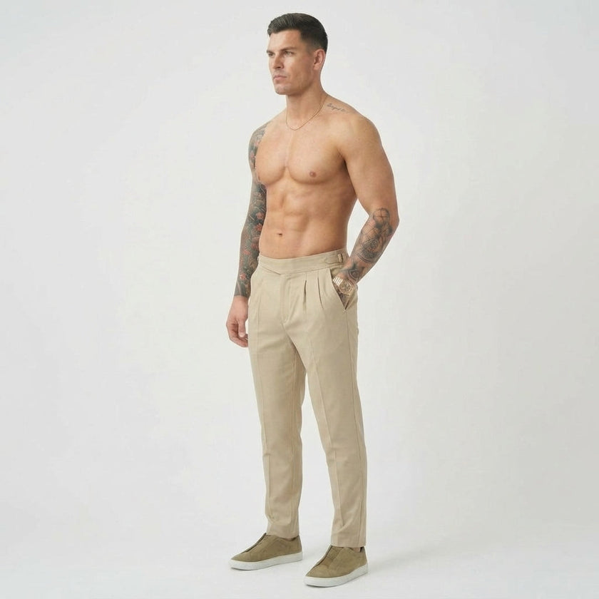 Men's tailored cream trousers from FJØRNA featuring a slim fit design and classic style, shown on a model.