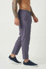 Men's cropped linen trousers in indigo by FJØRNA, showing relaxed fit with lightweight fabric and stylish design.